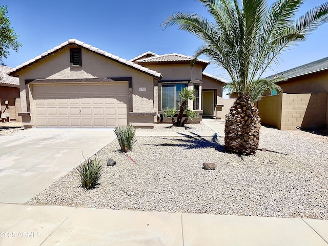 5749 S 247th Dr, Buckeye, AZ 85326 - view of front of home with stucco siding, driveway, a tile roof, and an attached garage