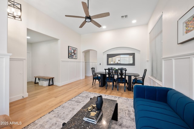 1748 E Cortez Dr, Gilbert, AZ 85234 - living area featuring visible vents, wood finished floors, ceiling fan, a wainscoted wall, and arched walkways