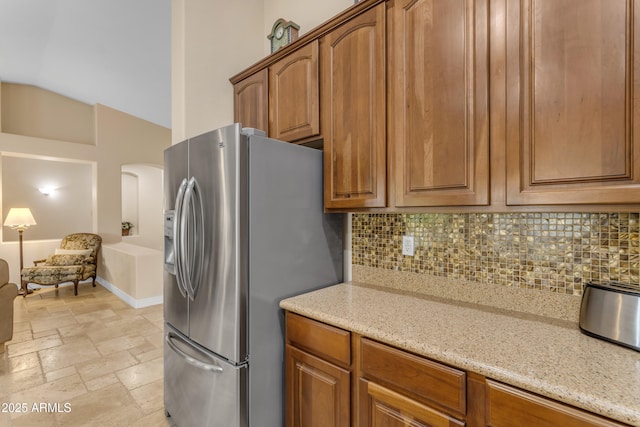 6870 S Justin Way, Chandler, AZ 85249 - kitchen featuring stainless steel fridge, decorative backsplash, light stone counters, and lofted ceiling