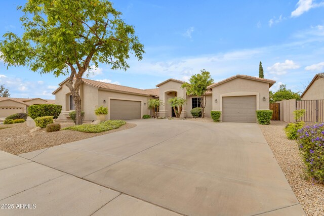 6870 S Justin Way, Chandler, AZ 85249 - mediterranean / spanish house with a garage, driveway, stucco siding, fence, and a tiled roof