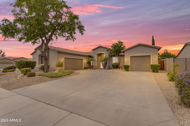6870 S Justin Way, Chandler, AZ 85249 - view of front of house featuring a garage, driveway, fence, stucco siding, and a tiled roof