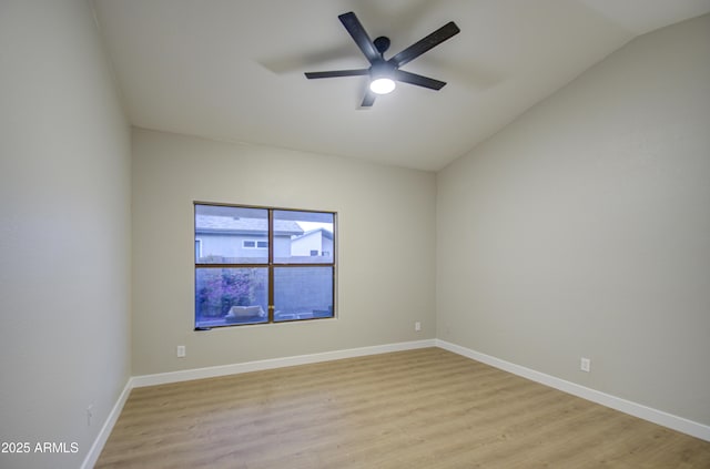 empty room featuring ceiling fan, lofted ceiling, and light hardwood / wood-style floors