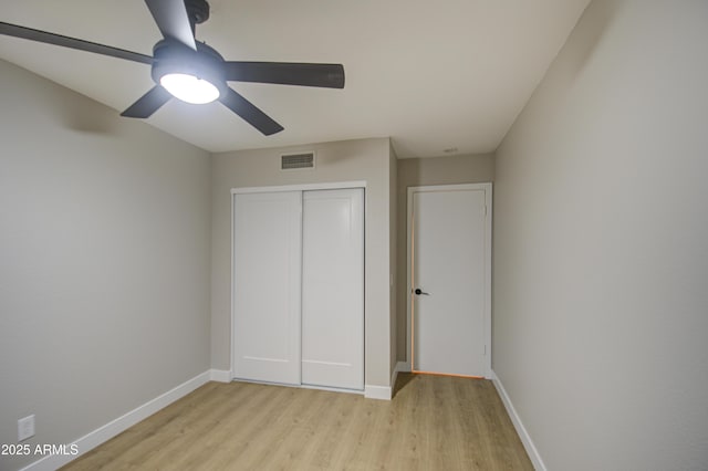 unfurnished bedroom with a closet, ceiling fan, and light hardwood / wood-style flooring