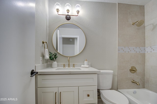 full bathroom with tiled shower / bath, vanity, and toilet