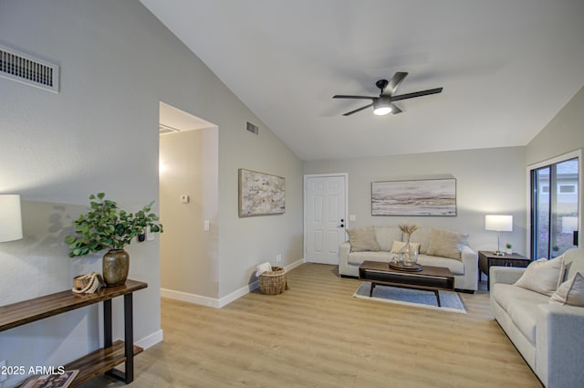 living room featuring ceiling fan, light hardwood / wood-style floors, and vaulted ceiling