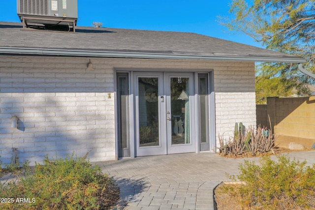 view of exterior entry with a patio area and french doors