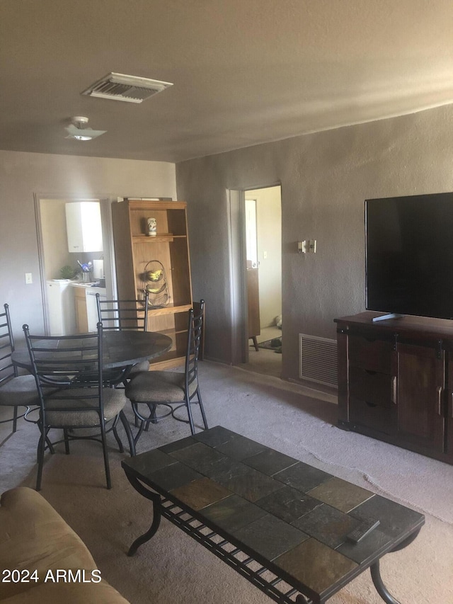 dining area with washer / clothes dryer and carpet