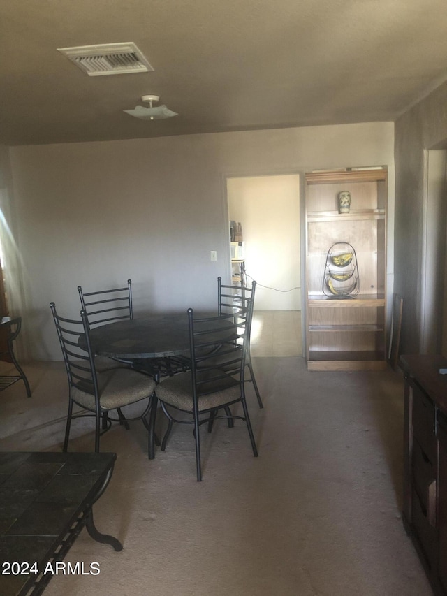 dining room featuring dark colored carpet