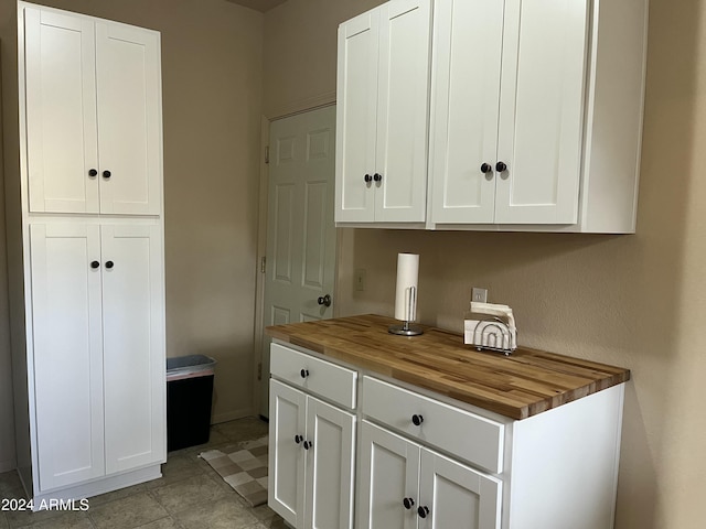 interior space featuring wood counters and white cabinetry