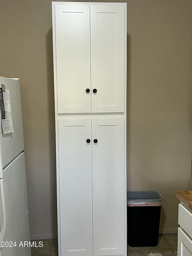 details with white fridge and white cabinets