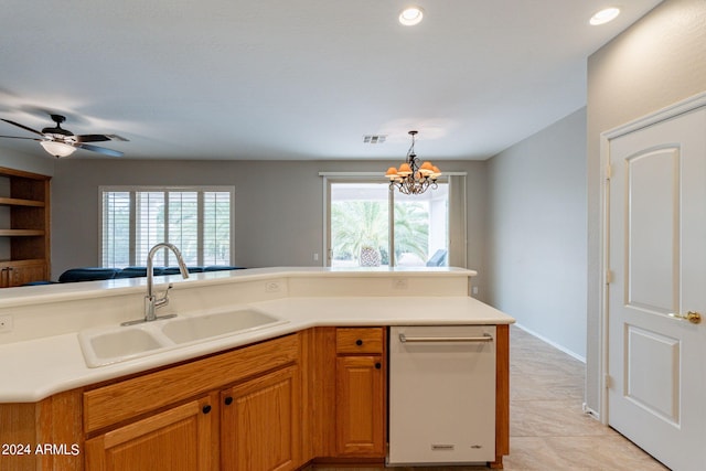 kitchen featuring visible vents, dishwasher, hanging light fixtures, light countertops, and a sink