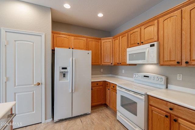 kitchen with white appliances, brown cabinetry, light countertops, and recessed lighting