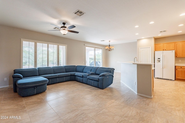 living room featuring baseboards, ceiling fan with notable chandelier, visible vents, and recessed lighting