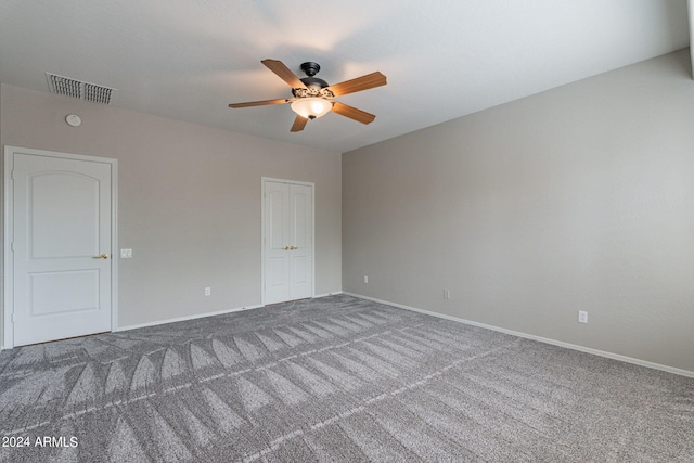 unfurnished room with baseboards, visible vents, ceiling fan, and carpet flooring