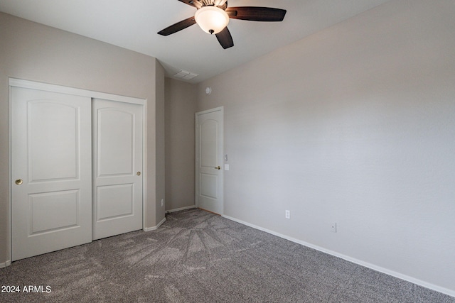 unfurnished bedroom with carpet floors, a closet, visible vents, ceiling fan, and baseboards