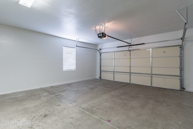 garage with baseboards and a garage door opener