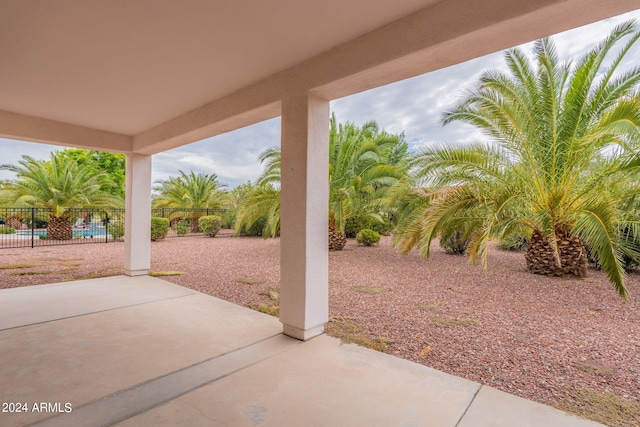 view of patio with fence and a fenced in pool