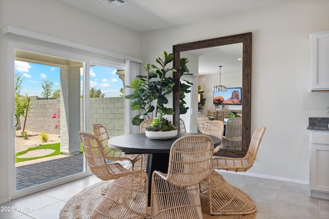 dining area with light tile patterned floors, visible vents, and baseboards