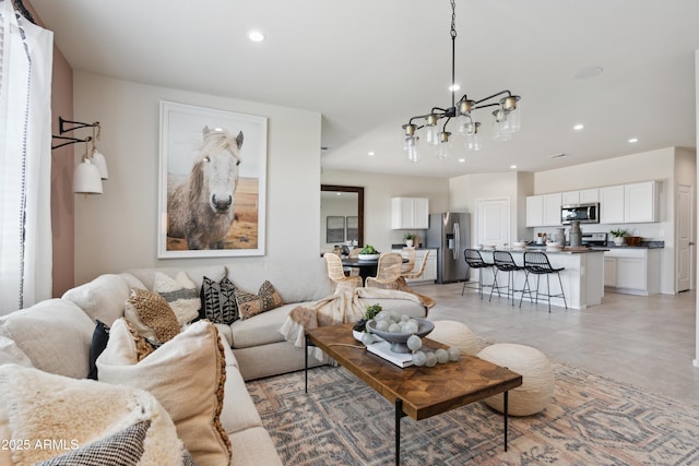 living area with a chandelier and recessed lighting