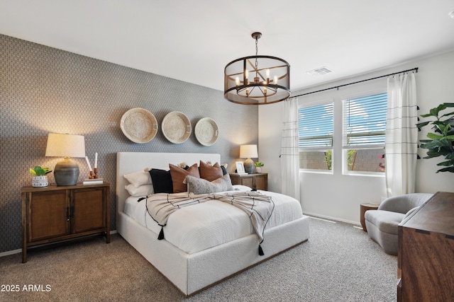 carpeted bedroom featuring wallpapered walls, visible vents, baseboards, an accent wall, and a notable chandelier