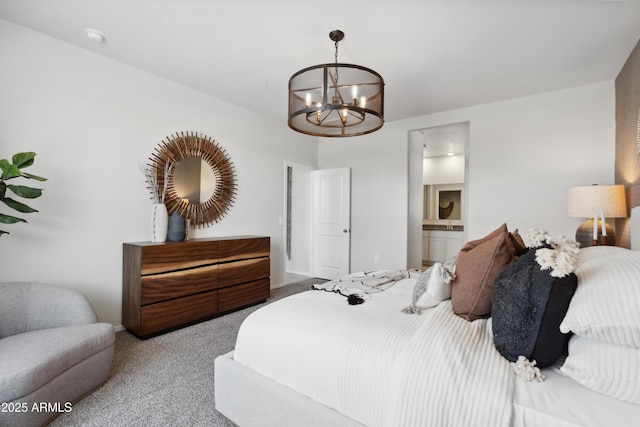 carpeted bedroom with a chandelier and ensuite bathroom