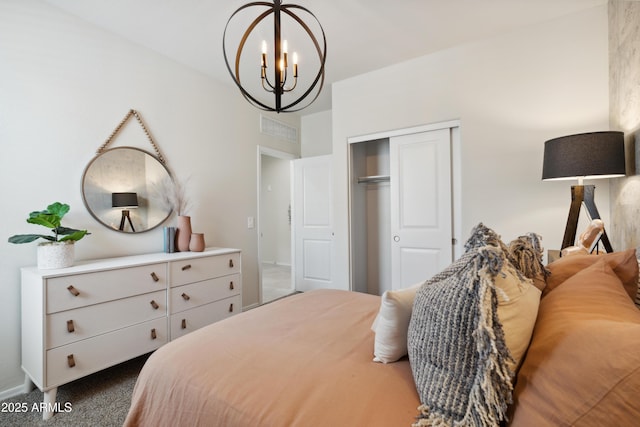 carpeted bedroom with a closet, visible vents, and a notable chandelier