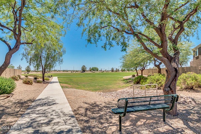 view of community with fence and a lawn