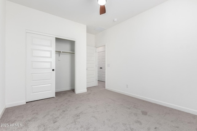 unfurnished bedroom with ceiling fan, light carpet, and a closet