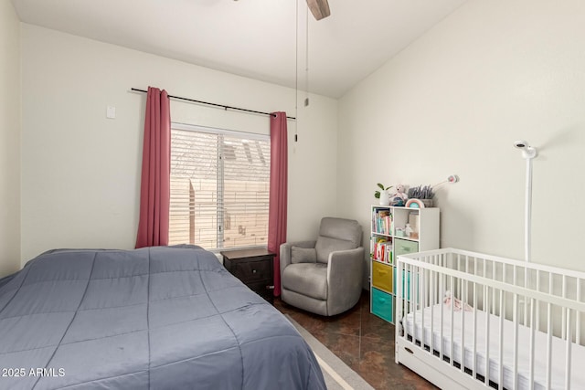 bedroom with a ceiling fan, concrete flooring, and lofted ceiling