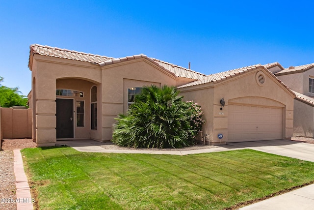 mediterranean / spanish home featuring an attached garage, a front lawn, stucco siding, a tiled roof, and driveway