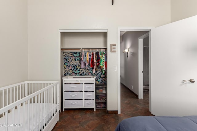 bedroom with stone finish floor and a closet