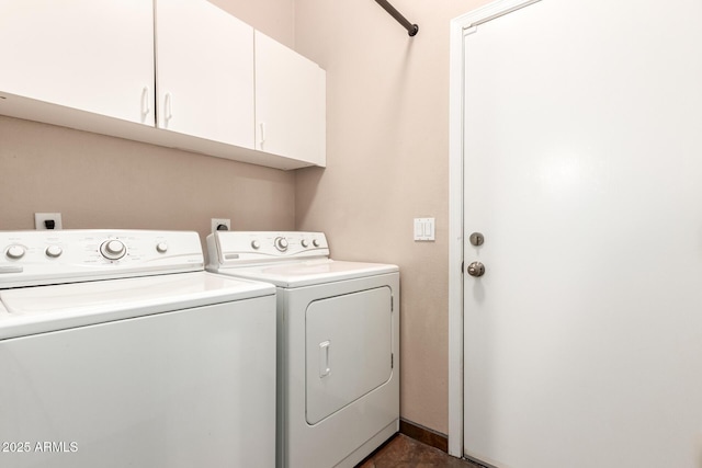 washroom featuring cabinet space and washer and clothes dryer