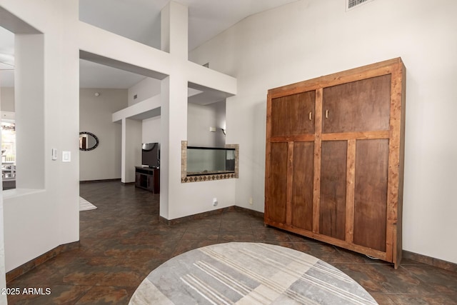entryway featuring baseboards and stone finish floor