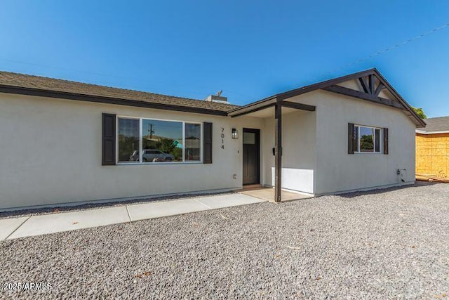 ranch-style house with stucco siding