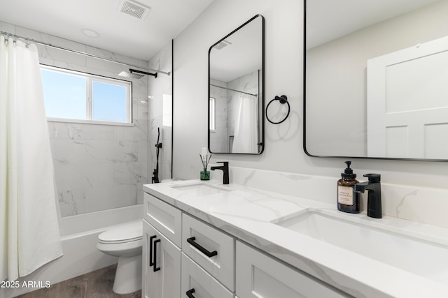 full bath with toilet, shower / bath combination with curtain, visible vents, and a sink