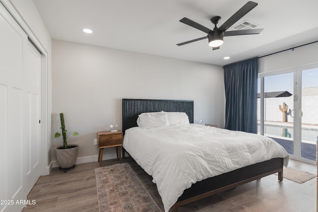 bedroom featuring recessed lighting, wood finished floors, visible vents, baseboards, and access to exterior