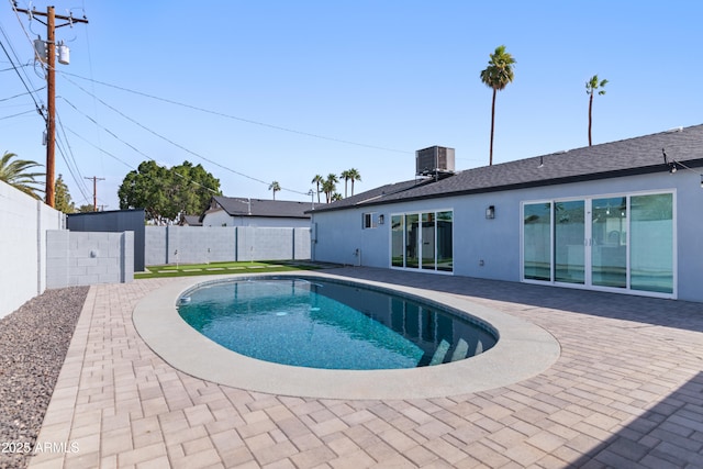 view of swimming pool with a patio area, a fenced backyard, and central air condition unit