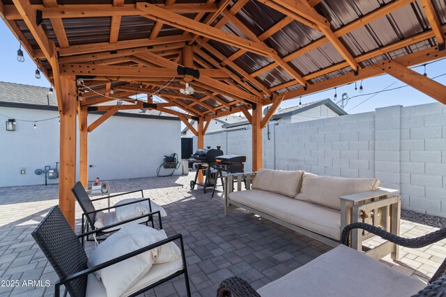 view of patio featuring an outdoor hangout area, fence, and outdoor dining area