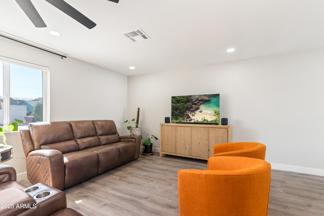 living room with baseboards, visible vents, a ceiling fan, light wood-style floors, and recessed lighting