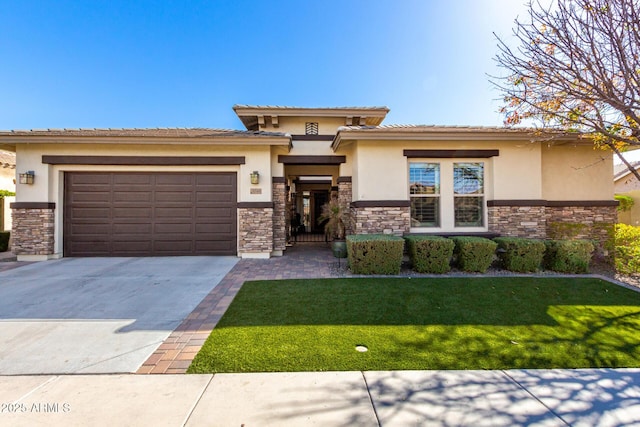 prairie-style house with a garage and a front lawn