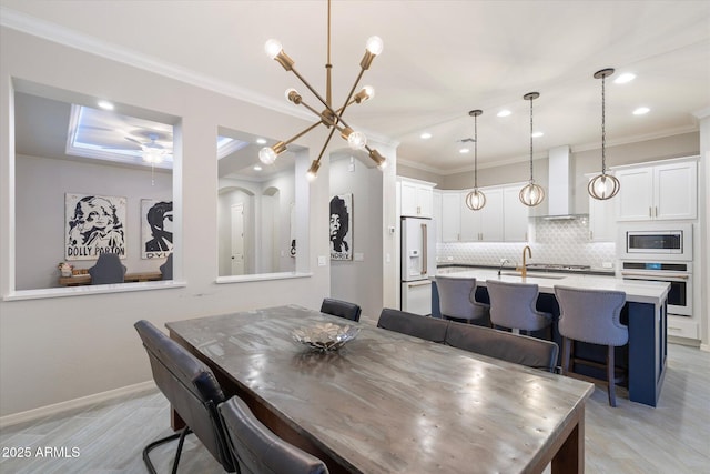 dining space featuring ceiling fan with notable chandelier, recessed lighting, baseboards, and ornamental molding