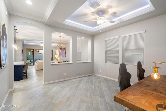 office area with visible vents, light wood-style floors, crown molding, and ceiling fan with notable chandelier