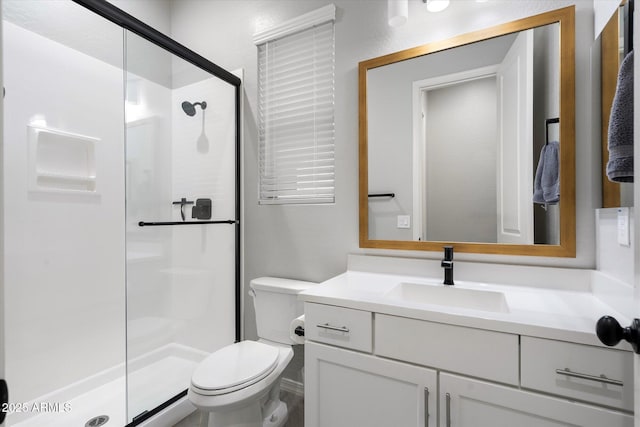 bathroom featuring a stall shower, toilet, and vanity