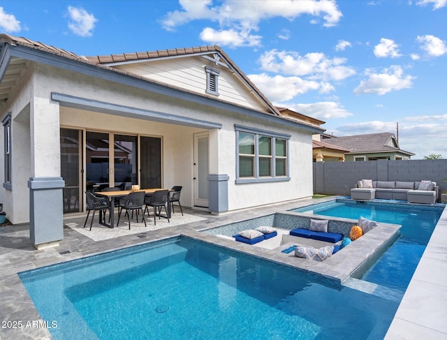 back of property featuring outdoor lounge area, an outdoor hot tub, a patio area, and fence