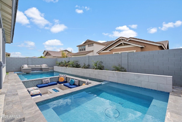 view of pool with outdoor lounge area, an in ground hot tub, a fenced backyard, and a patio