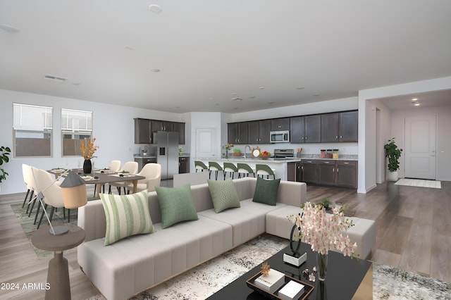 living area featuring visible vents and wood finished floors