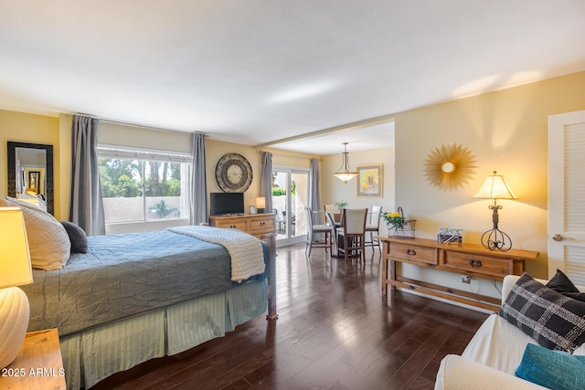 bedroom with dark wood-style flooring and access to outside