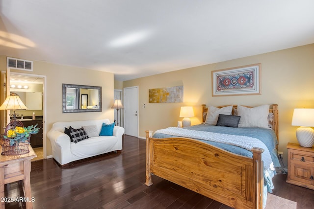 bedroom with visible vents and wood finished floors