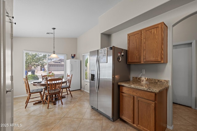 3905 E Derringer Way, Gilbert, AZ 85297 - kitchen with stainless steel fridge, plenty of natural light, freestanding refrigerator, and brown cabinets