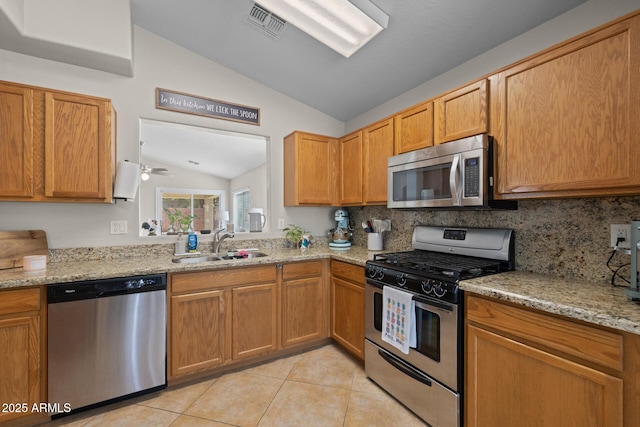 3905 E Derringer Way, Gilbert, AZ 85297 - kitchen featuring stainless steel appliances, vaulted ceiling, light tile patterned floors, light stone counters, and ceiling fan